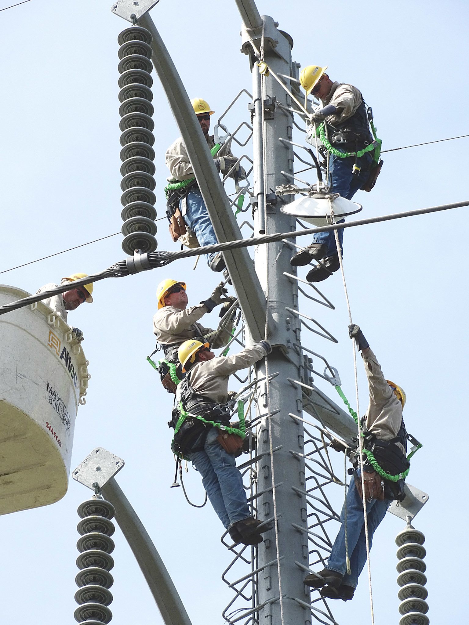 Apprentices working on transmission tower
