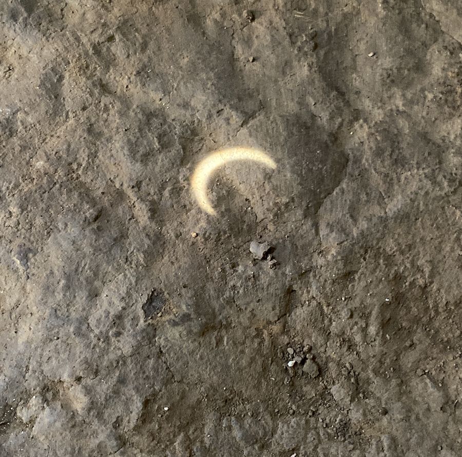 Shadow of October 14, 2023, eclipse on dirt floor of house