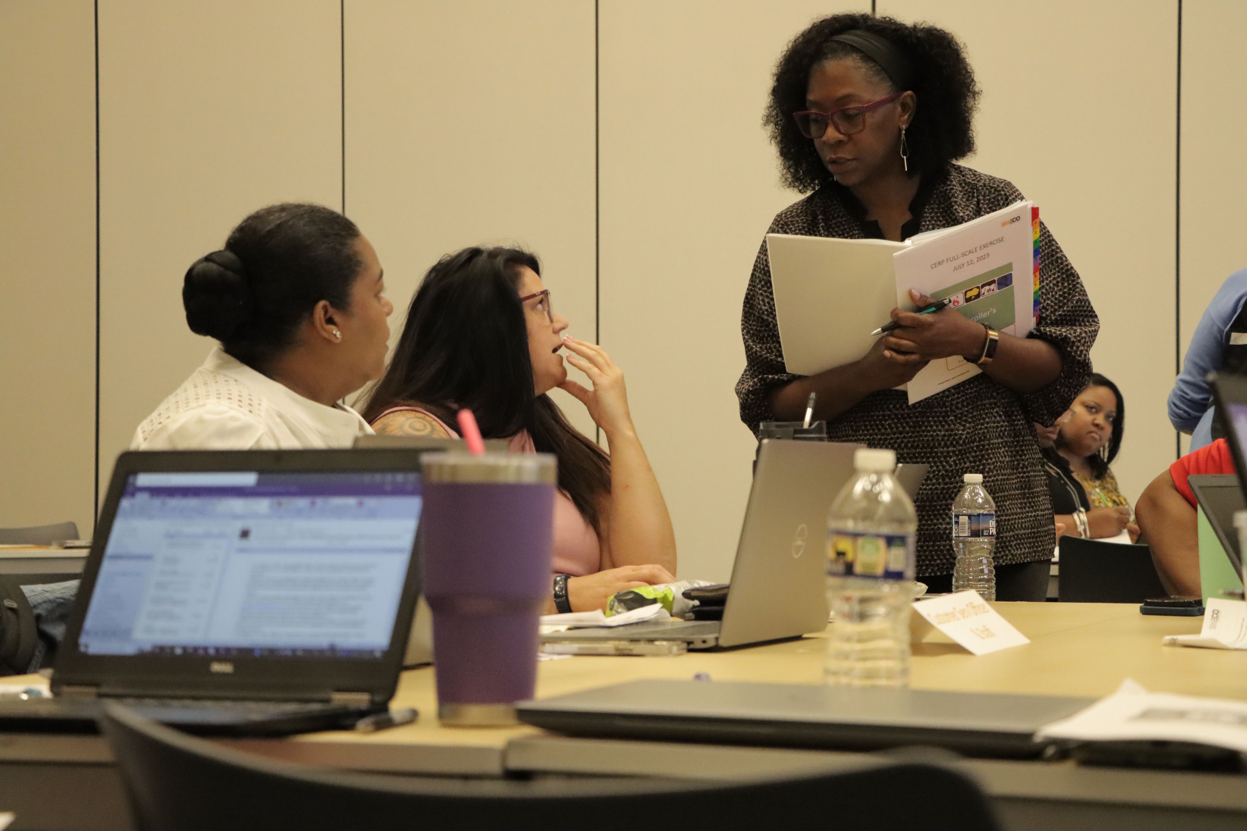 Employees confer during a tabletop exercise